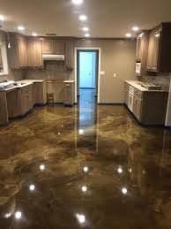 Spacious modern kitchen with polished concrete floor and wooden cabinetry.