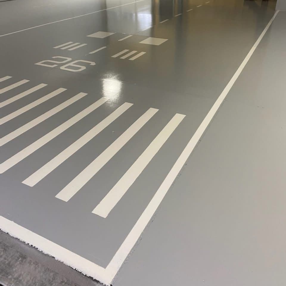 Custom Runway-Themed Epoxy Floor in a Private Hangar image
